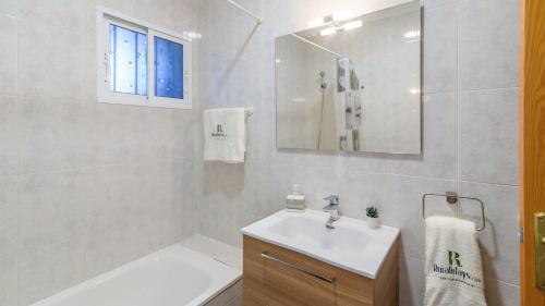 a white bathroom with a sink and a mirror at Villa Quevedo Torrox by Ruralidays in Torrox