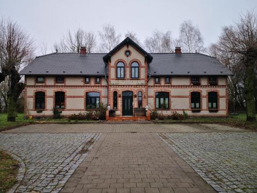 a large brick house with a black roof at Gutshaus Breesen in Laage