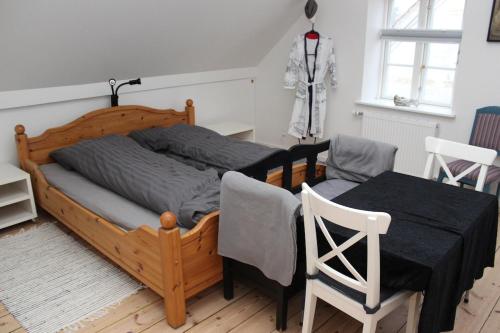 a bedroom with a bed and a table and chairs at 1st floor 2 rooms with kitchenette in Store Heddinge