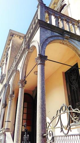 a building with columns and a balcony with a gate at L'Antico Lido Venice in Venice-Lido