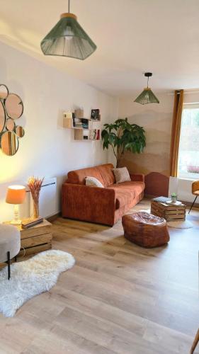 a living room with a couch and a table at Le Royal Billy in Dreux