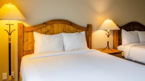 a bedroom with two beds and two lamps at Cahilty #434 home in Sun Peaks