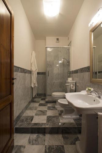 a bathroom with a sink and a toilet and a shower at Relais Villa Scarfantoni B&B in Montemurlo