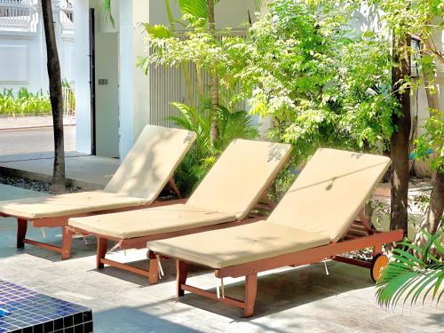 two chairs and a bench on a patio at SkyVilla BKK - Pool & Chill - Laundry included in Phnom Penh