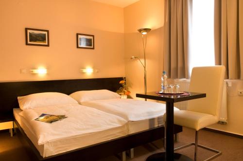 Posteľ alebo postele v izbe v ubytovaní Franko hotel