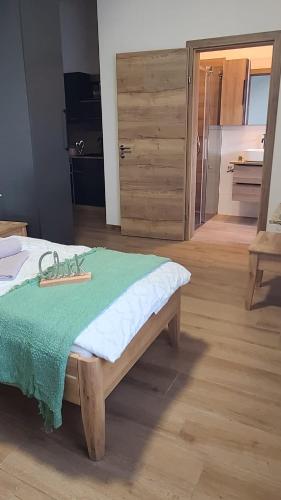 a bedroom with a bed with a green blanket on it at BestFriends-Lenzing in Lenzing