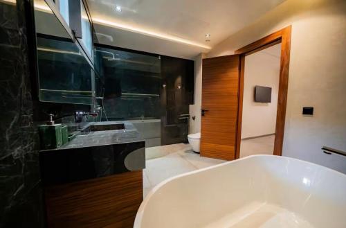 a bathroom with a large white tub and a sink at Villa Horizon in Marrakesh