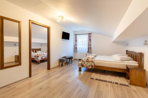a bedroom with a bed and a large mirror at Pensiunea Casa Brancovenilor in Sâmbăta de Sus