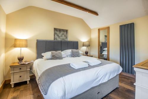 a bedroom with a large bed with two towels on it at 3 Bed in Brampton oc-g34639 in Brampton