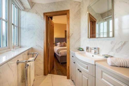 a bathroom with a sink and a mirror and a bed at 3 Bed in Brampton oc-g34639 in Brampton