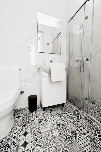 a white bathroom with a sink and a shower at Cosyroom 3 in Pieta