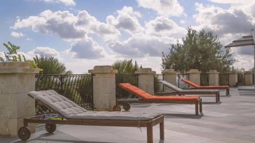 a group of lounge chairs sitting on a patio at Tenuta Olive Alive in Noto