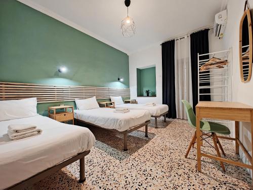 a hotel room with two beds and a desk at Cosyroom 3 in Pieta