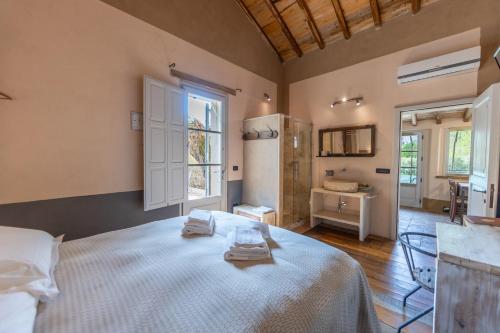 a bedroom with a bed with two towels on it at B&B Il Molinello in Asciano