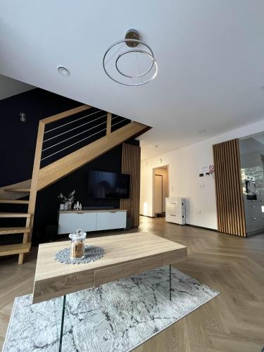 a living room with a tv and a table at Opole Calm House in Opole