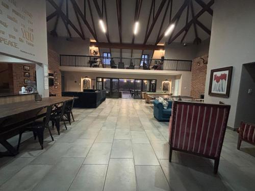a large room with tables and chairs and a large room at House 110 in Hoedspruit