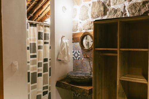 a bathroom with a sink and a mirror at Posada Los Tres Arrieros in Jordán