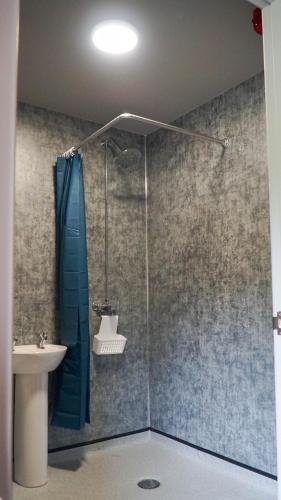 a bathroom with a shower and a sink at 3 Peaks Bunkroom in Settle