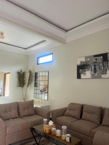 a living room with two couches and a table at Kulla villa dieng in Wonosobo