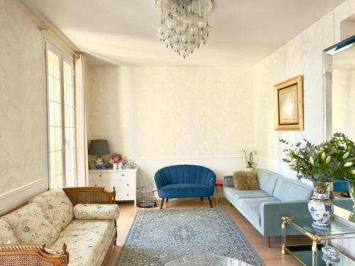 a living room with a couch and a blue chair at Luxury Tenao palace, Monaco border, sea view in Beausoleil