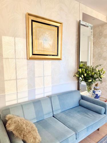 a blue couch in a living room with a mirror at Luxury Tenao palace, Monaco border, sea view in Beausoleil
