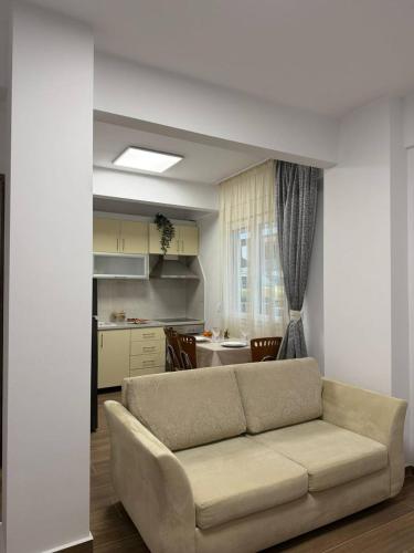 a living room with a couch and a kitchen at Le Grace, Urban Retreat near Near CityCenter & Sea in Thessaloniki