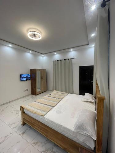 a bedroom with a large bed in a room at JudEls SA Guest House in Accra