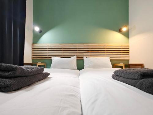 a bedroom with a large white bed with two pillows at Cosy room 2 in Pieta