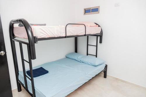 a bunk bed in a room with a bunk bed in a room at Apartamentos King Arthur in Punta Seca