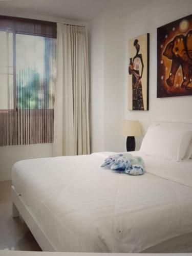 a bedroom with a large white bed with a window at Star light hotel in Monterrey