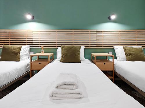 a room with two beds and two side tables at Cosy room 1 in Pieta