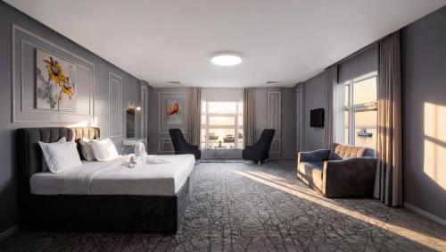 a hotel room with a bed and a couch at Golden Garden Al Corniche in Dammam