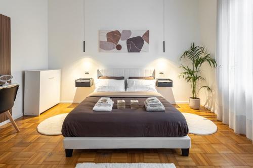 a bedroom with a large bed with two towels on it at B&B di Dante in Legnano