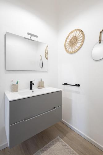 a bathroom with a white sink and a mirror at B&B di Dante in Legnano