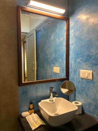 a bathroom with a sink and a mirror at Savana Stay - A Boutique Hotel in Pondicherry