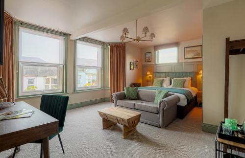 a hotel room with a bed and a couch at Brewhouse & Kitchen - Southbourne in Bournemouth