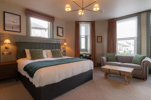 a bedroom with a large bed and a couch at Brewhouse & Kitchen - Bournemouth - Southbourne in Bournemouth