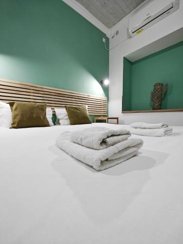 a large white bed with towels on top of it at Cosy room 4 in Pieta