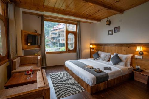 a bedroom with a large bed and a window at THE LANDSBY COTTAGES in Nagar