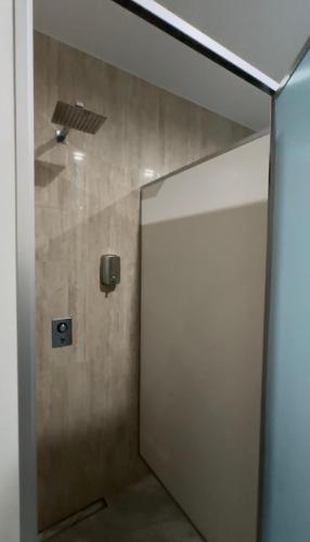 a bathroom with a shower with a sliding door at Галичанка Еліт SPA in Gornyak