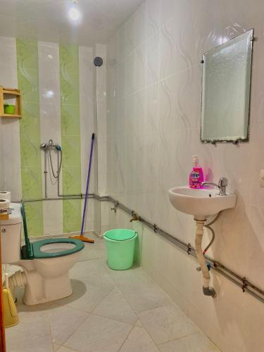 a bathroom with a sink and a toilet and a mirror at Ahmed mirleft in Sidi Ifni