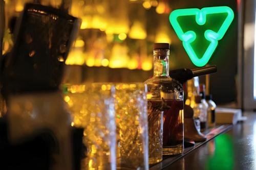 a bottle of alcohol sitting on a bar with glasses at Elephant In The Room in Istanbul