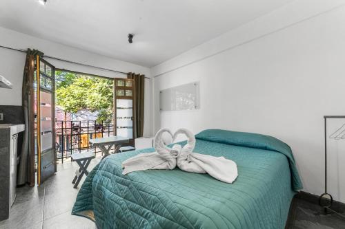 a bedroom with a bed with a bow on it at Suites Calle Berlin in Mexico City