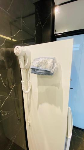 a white refrigerator with a towel on the door at Pousada Jabuticabeira in Jaguaruna