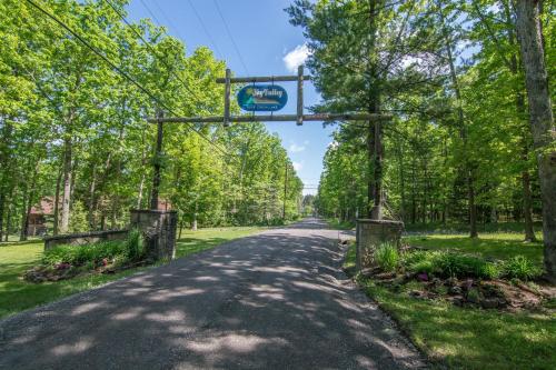 a road in a park with a sign on it at Woodlore by Railey Vacations in Swanton