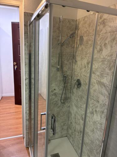 a shower with a glass enclosure in a room at Casa Nietta in Olbia