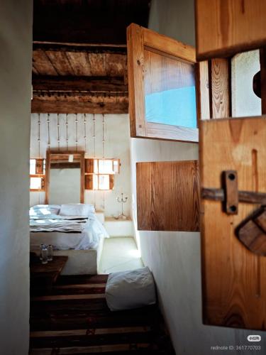 a small room with two beds and a door at Tanirt ecolodge in Siwa