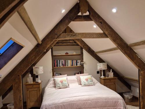 a bedroom with a bed and a book shelf at The Old Mill Annexe in Jacobstowe