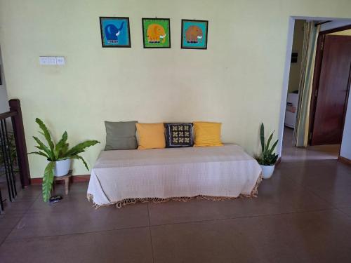 a bed in a room with some pillows on it at ADLi in Belihuloya