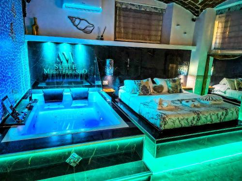 a room with a tub and a bed and a couch at Suite Mediterraneo in Civitavecchia